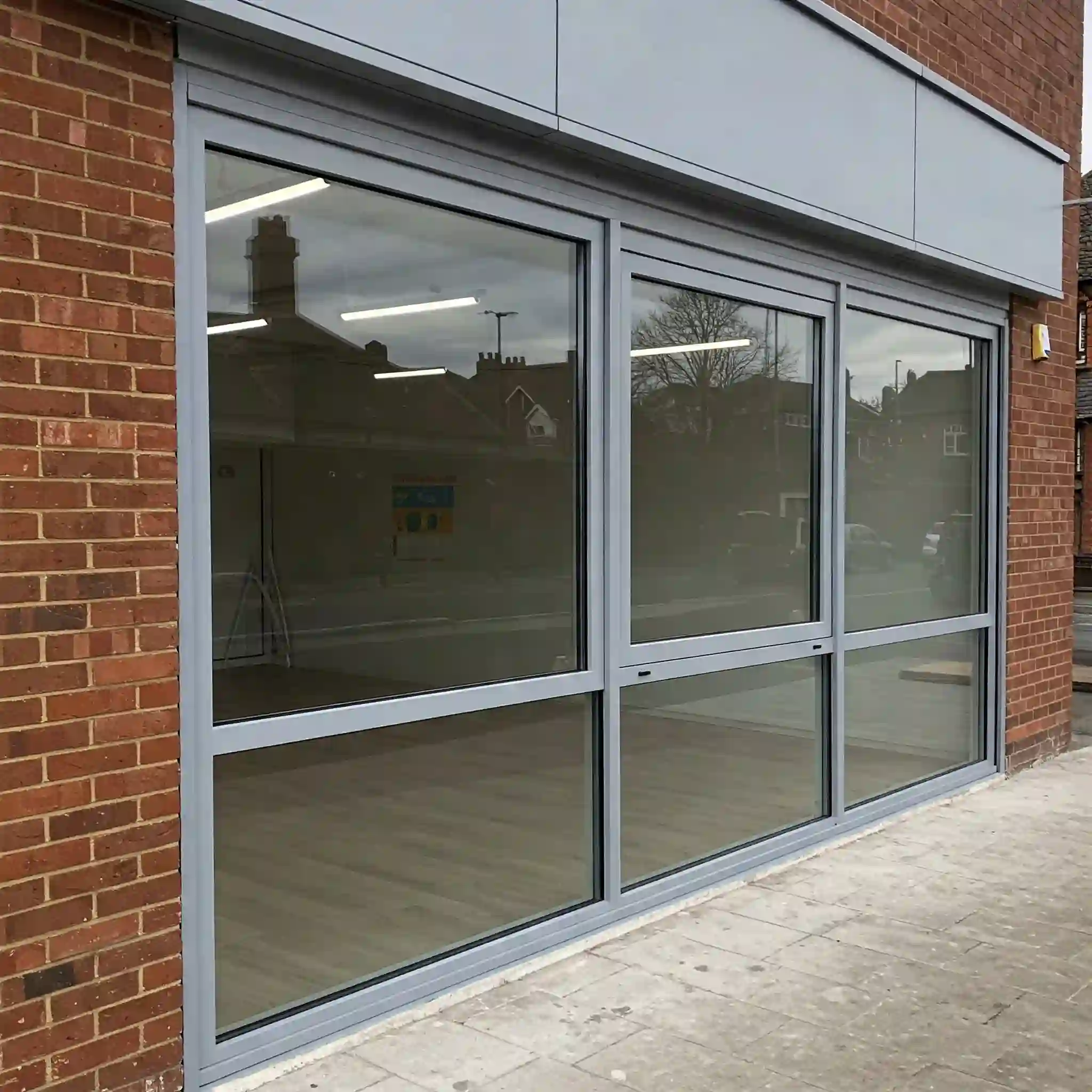 Professional glazier repairing window in UK